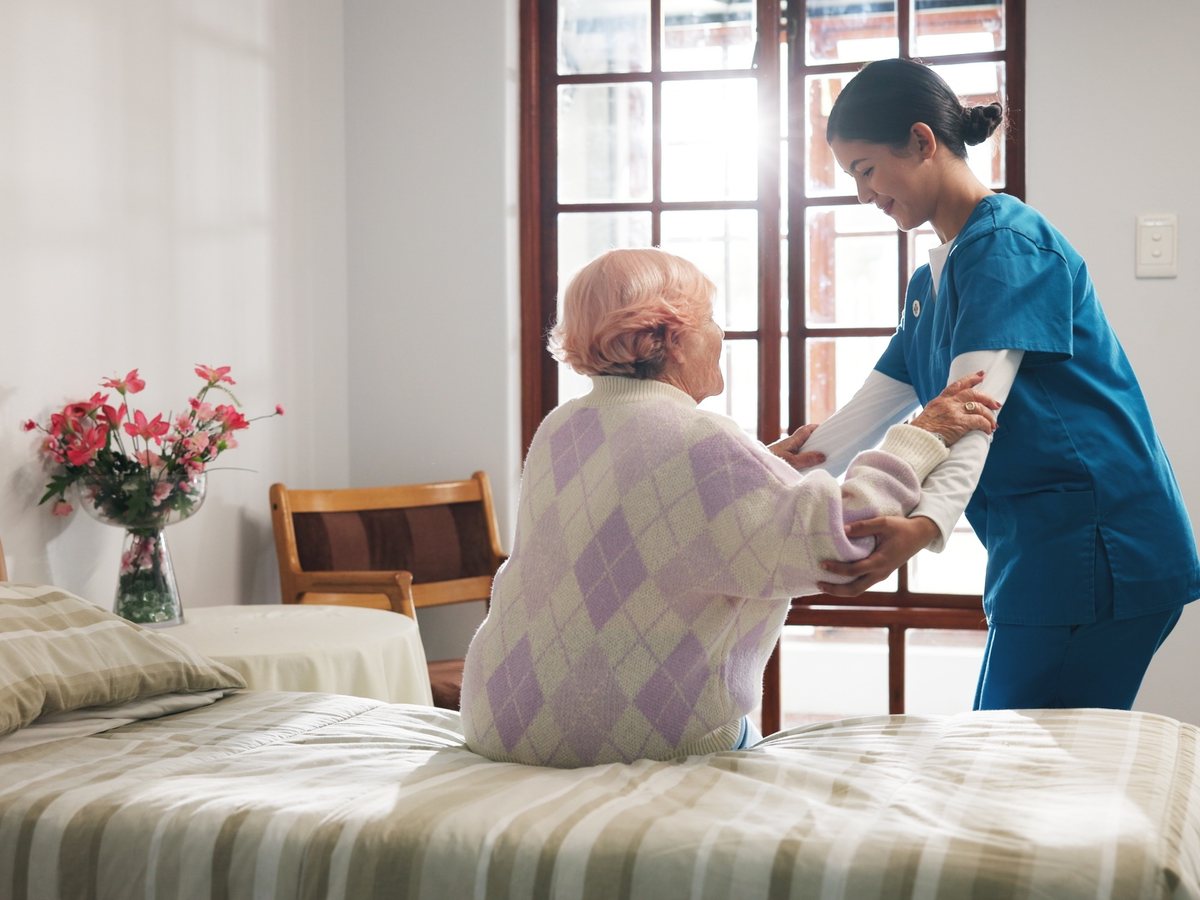 Hospice caregiver at a patient's bedside